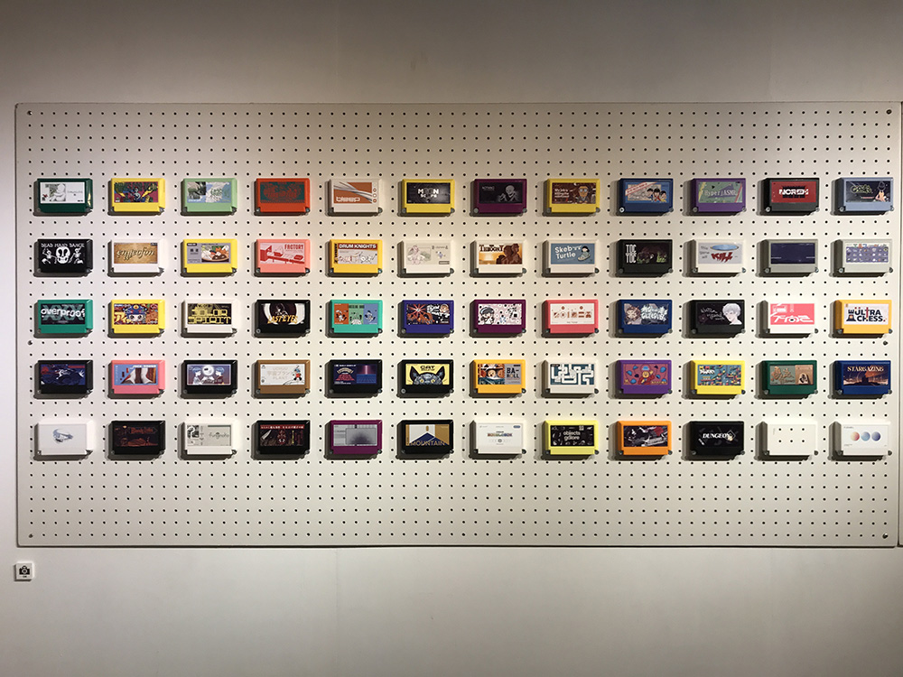 White pegboard on a wall covered with cartridges.