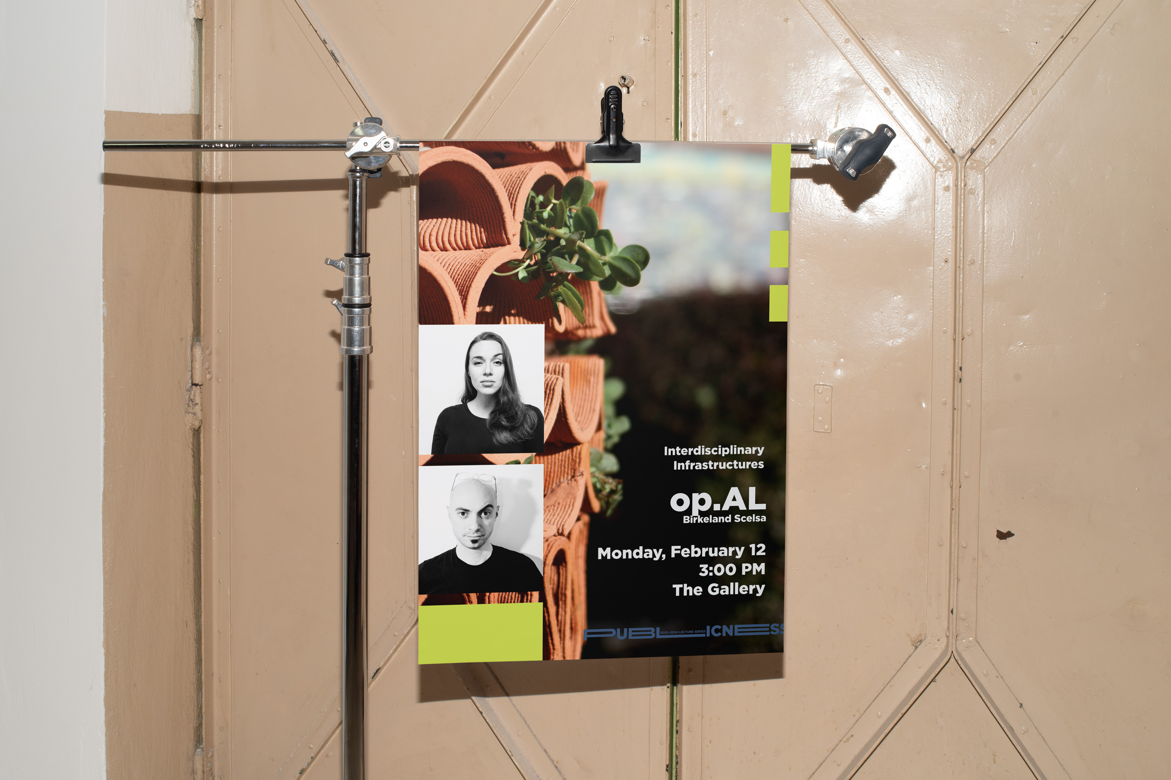 A poster clipped to a tripod with a yellow wall background. Poster is from the opAL lecture, feature the two architects that principal the firm and a graphic of their work.